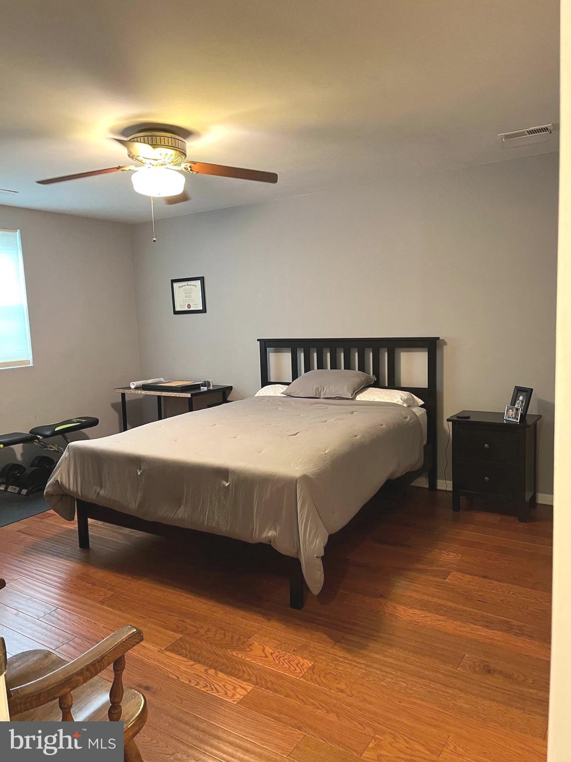 100 Castletown Road, Unit 101 Lutherville-Timonium, MD 21093 - Photo 16 of 18 a bedroom with a bed and a chandelier