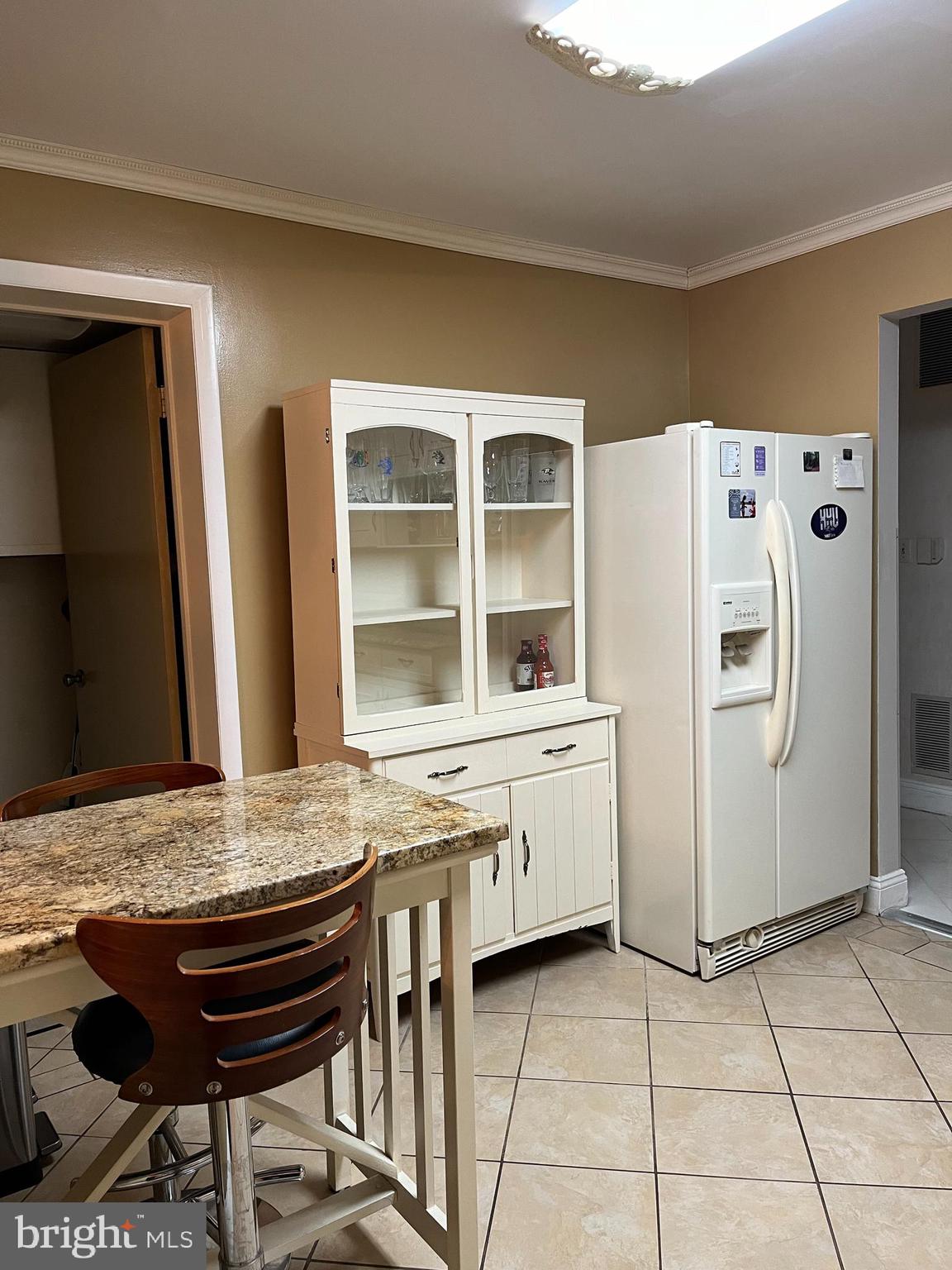 100 Castletown Road, Unit 101 Lutherville-Timonium, MD 21093 - Photo 7 of 18 a kitchen with stainless steel appliances granite countertop a refrigerator and a stove top oven