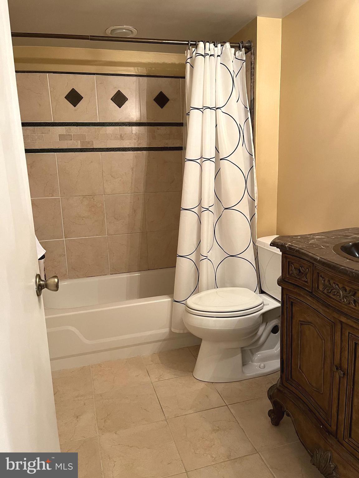 100 Castletown Road, Unit 101 Lutherville-Timonium, MD 21093 - Photo 8 of 18 a white toilet sitting next to a bathroom sink