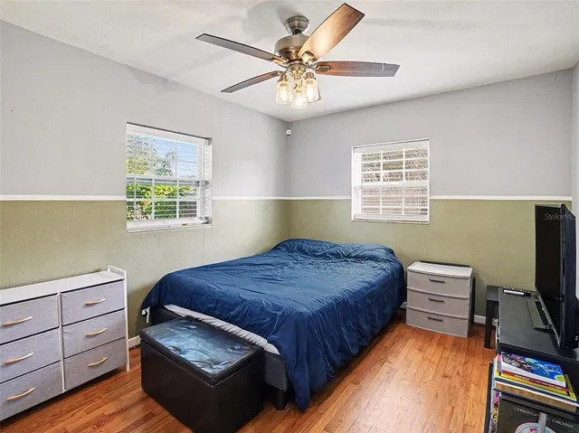 a bedroom with a bed and a chandelier