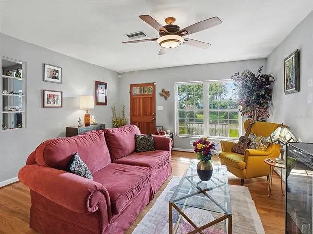 a living room with furniture large window and a flat screen tv