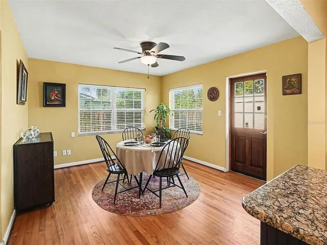a view of a dining room with furniture window and wooden floor