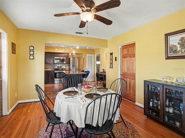 a dining room with furniture a rug and wooden floor