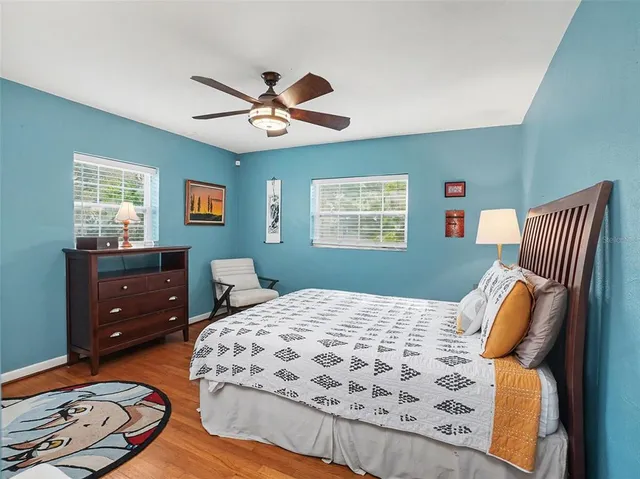 a bedroom with a bed and wooden floor