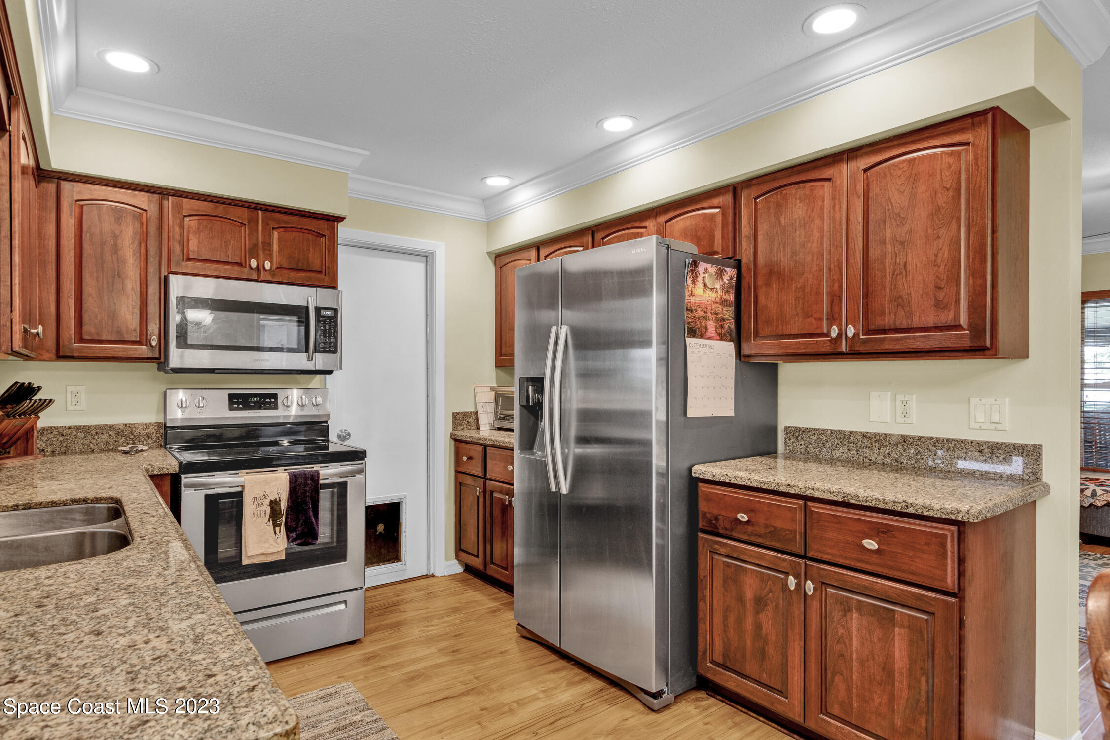461 Easy Street Sebastian, FL 32958 - Photo 12 of 31 a kitchen with stainless steel appliances granite countertop a refrigerator stove and sink