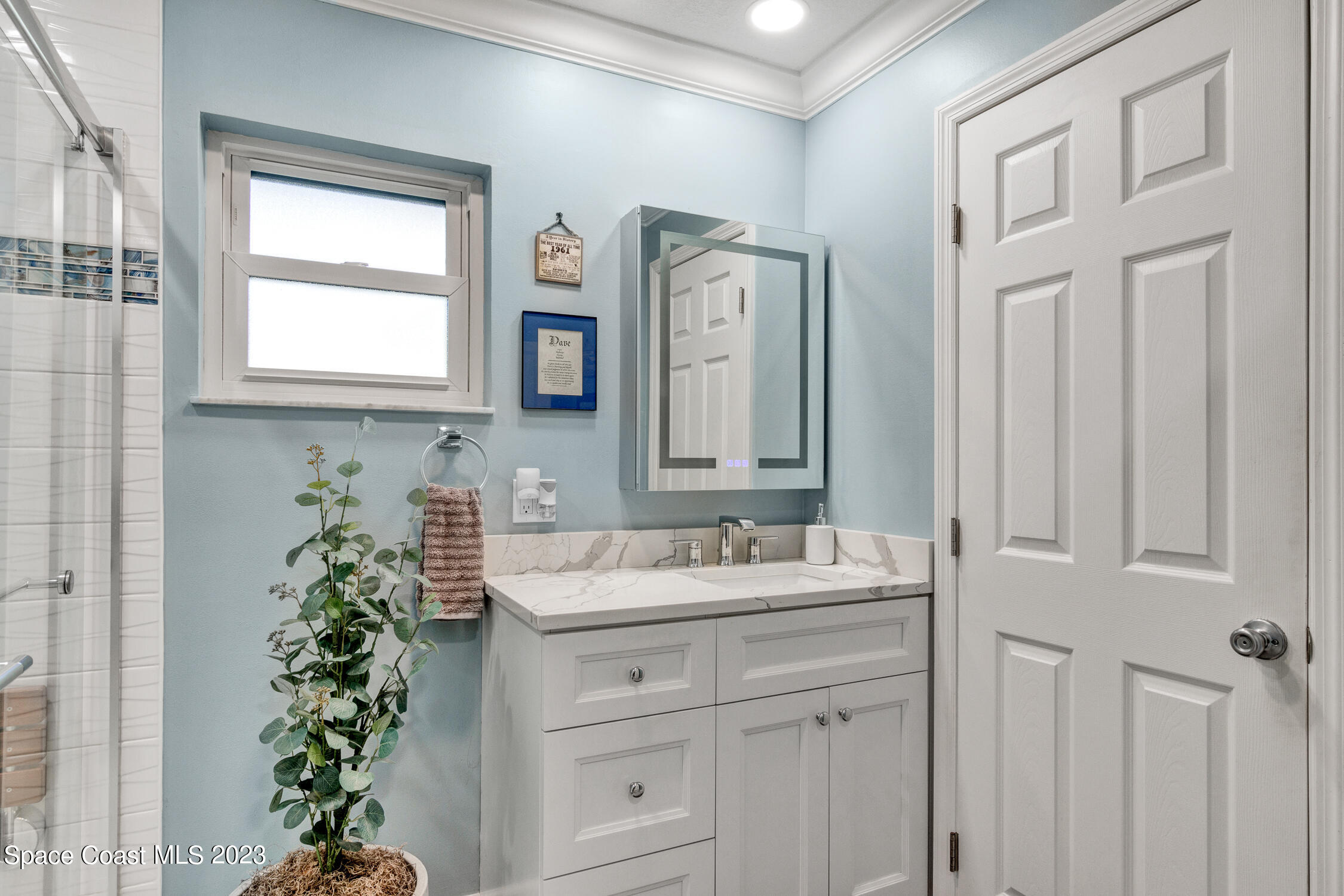 461 Easy Street Sebastian, FL 32958 - Photo 17 of 31 a bathroom with a sink a mirror and a window
