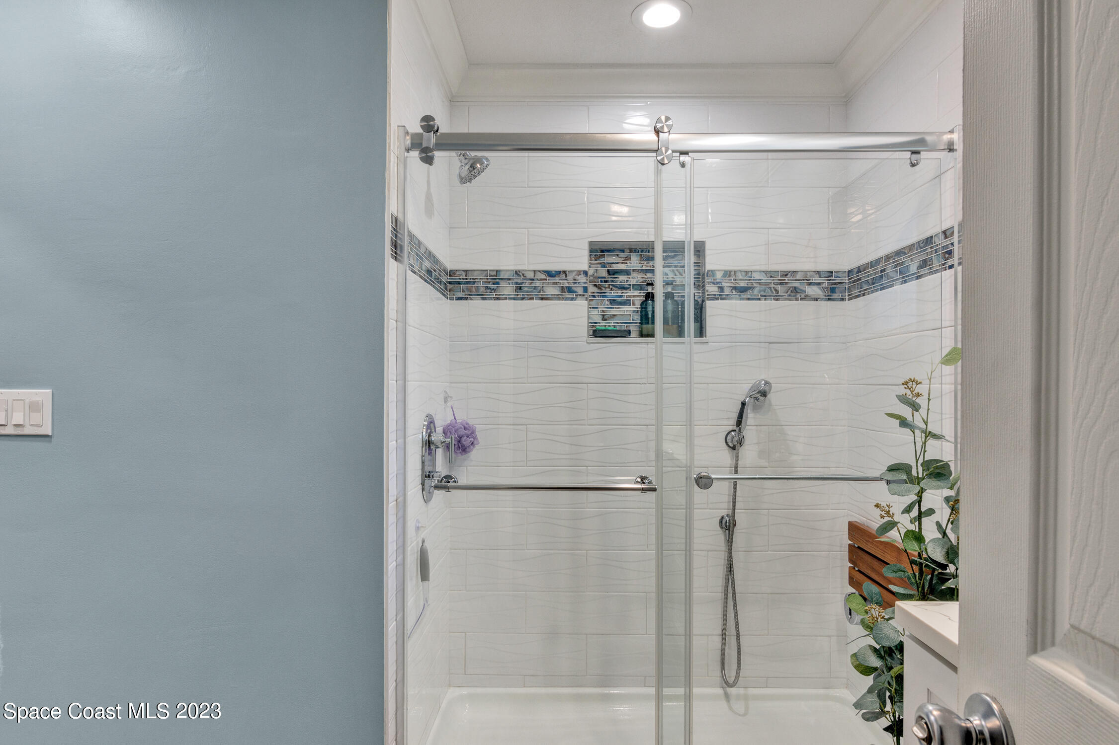461 Easy Street Sebastian, FL 32958 - Photo 18 of 31 a bathroom with a glass shower door