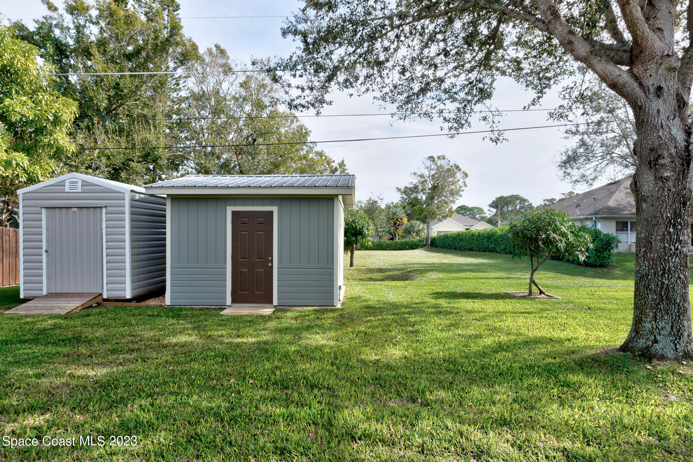 461 Easy Street Sebastian, FL 32958 - Photo 22 of 31 a view of a house with a yard and a large tree