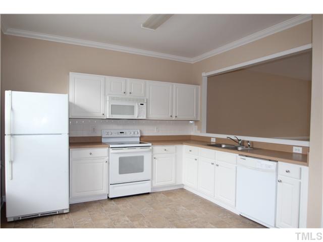 5308 Glen Canyon Road Raleigh, NC 27616 - Photo 3 of 12 a kitchen with granite countertop white cabinets and white appliances