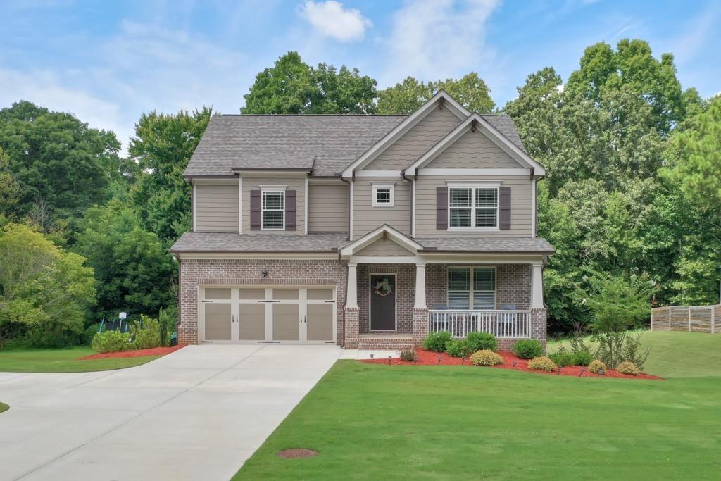 4688 Cantrell Road Flowery Branch, GA 30542 - Photo 1 of 39 front view of a house next to a yard