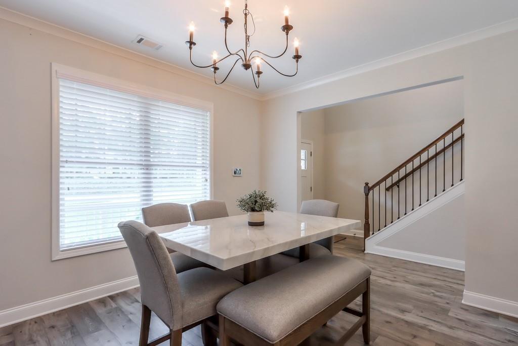 4688 Cantrell Road Flowery Branch, GA 30542 - Photo 11 of 39 a view of a dining room with furniture window and wooden floor