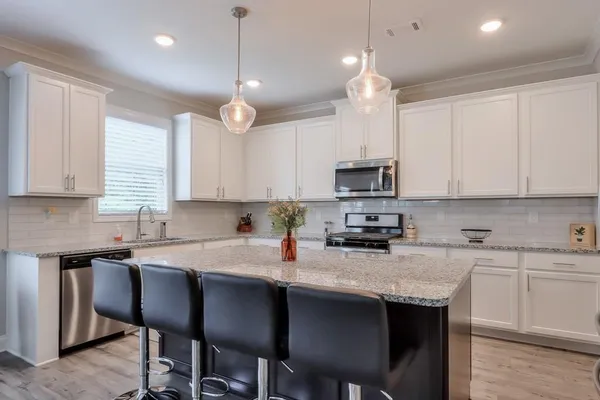 a kitchen with a sink cabinets and window