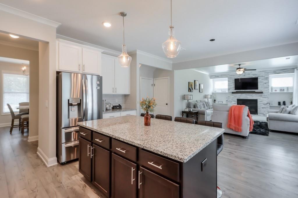 4688 Cantrell Road Flowery Branch, GA 30542 - Photo 15 of 39 a kitchen with stainless steel appliances granite countertop a sink refrigerator and cabinets