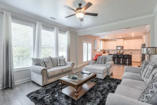 a living room with furniture and a large window