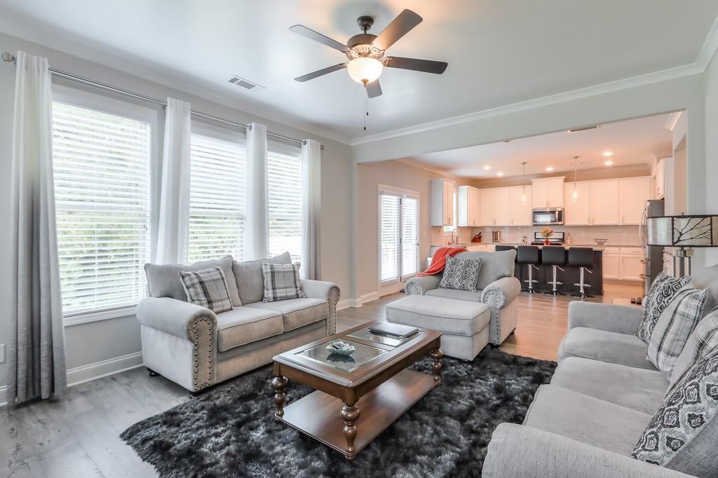 4688 Cantrell Road Flowery Branch, GA 30542 - Photo 19 of 39 a living room with furniture and a large window