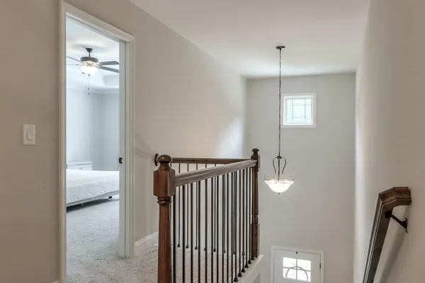 a view of a hallway with a livingroom and a window