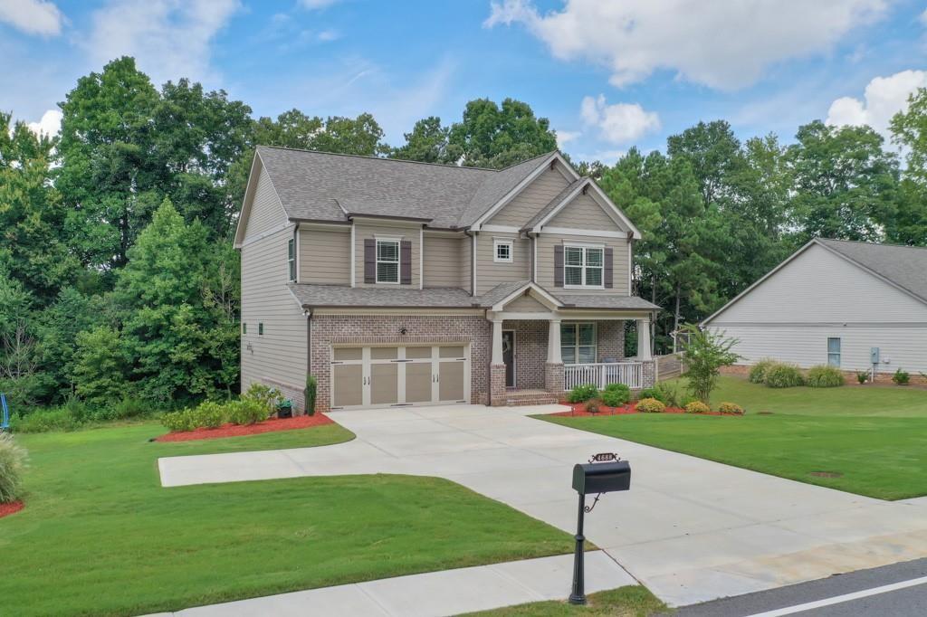 4688 Cantrell Road Flowery Branch, GA 30542 - Photo 2 of 39 a front view of a house with a yard and trees