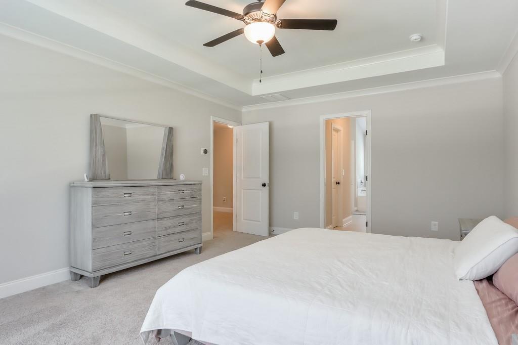 4688 Cantrell Road Flowery Branch, GA 30542 - Photo 23 of 39 a bedroom with a bed and a dresser