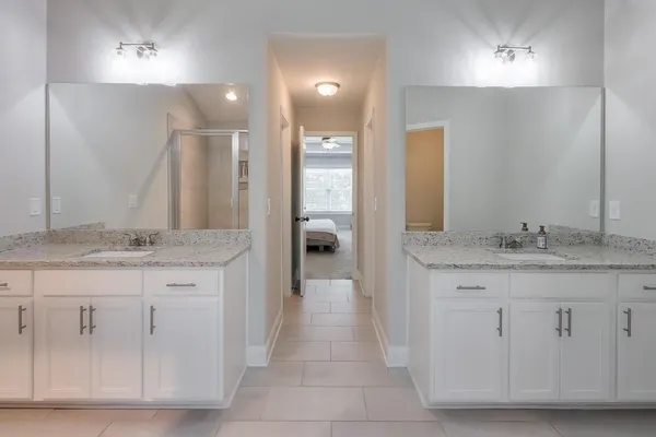 a bathroom with a granite countertop sink a toilet and a vanity