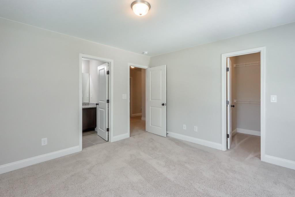 4688 Cantrell Road Flowery Branch, GA 30542 - Photo 27 of 39 an empty room with closet and a bathroom