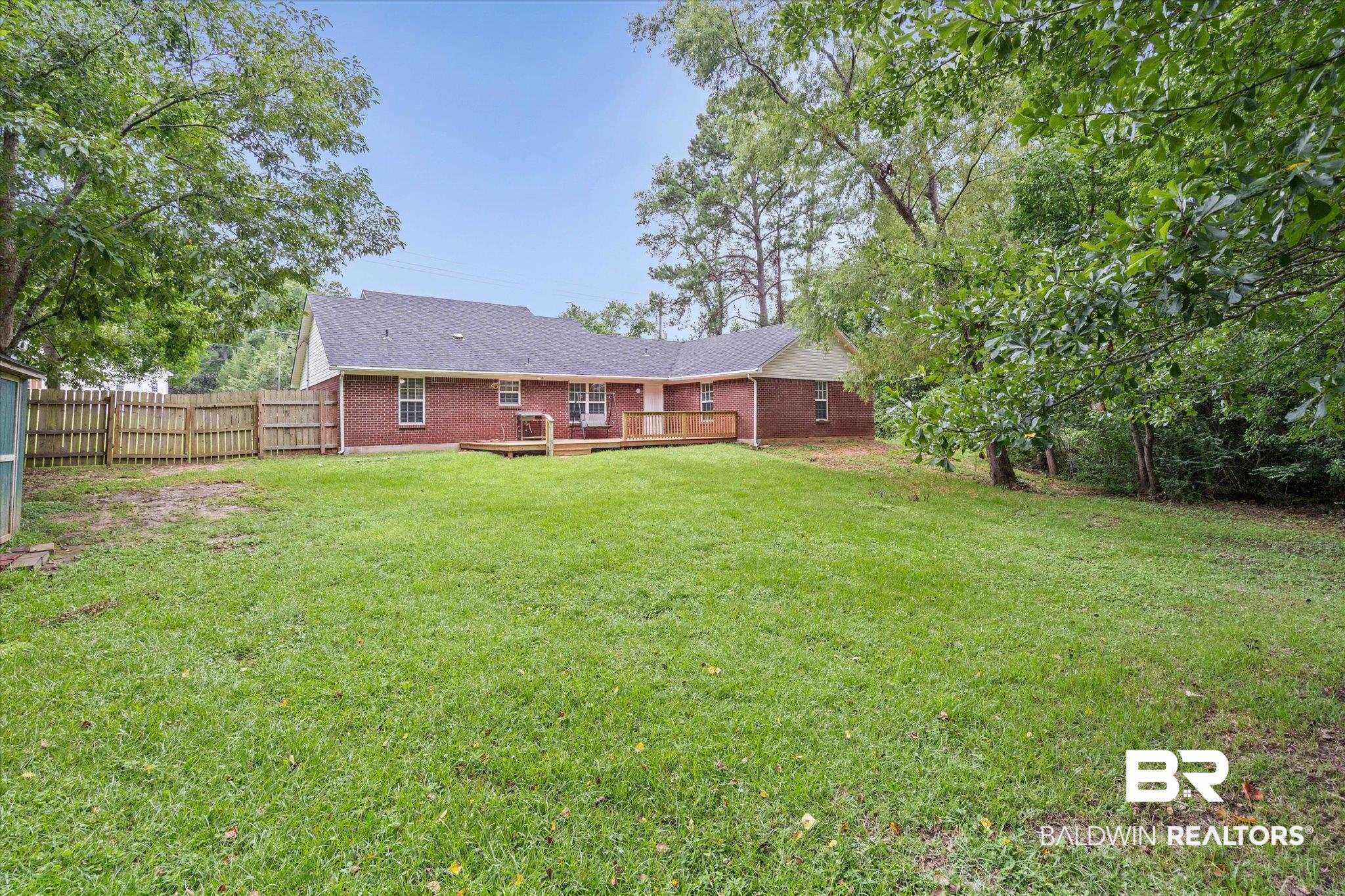 157 Bay View Drive Daphne, AL 36526 - Photo 16 of 22 Back of property with a deck, brick siding, and roof with shingles