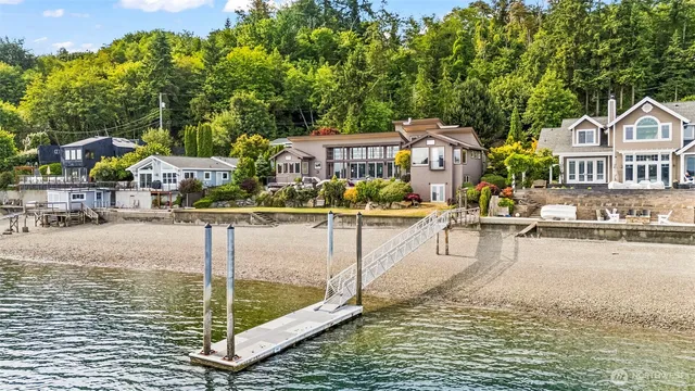 a balcony with chairs and an umbrella