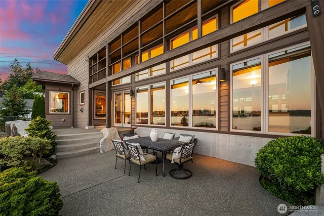 a view of a patio with a table and chairs and potted plants