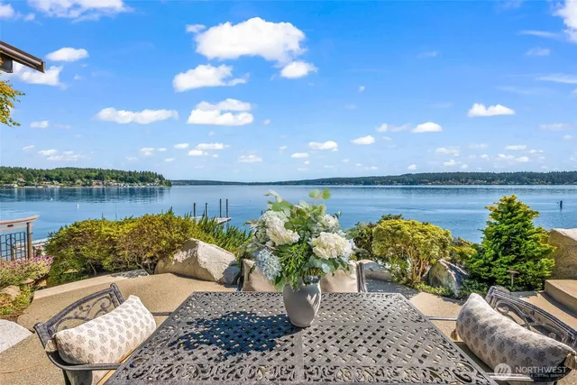 a view of a patio with furniture and a garden