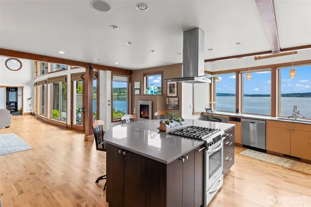 a kitchen with stainless steel appliances kitchen island granite countertop a sink and cabinets