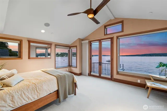 a spacious bedroom with a large bed and a large window