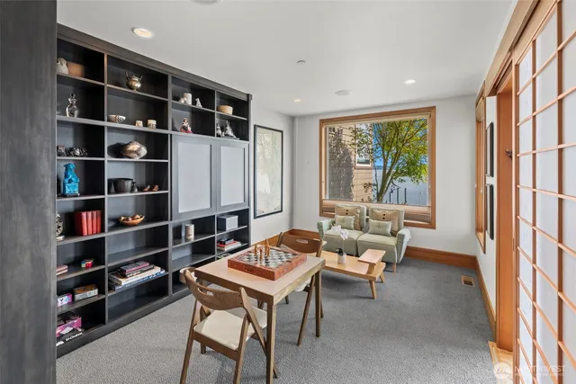 a living room with furniture a rug and a large window