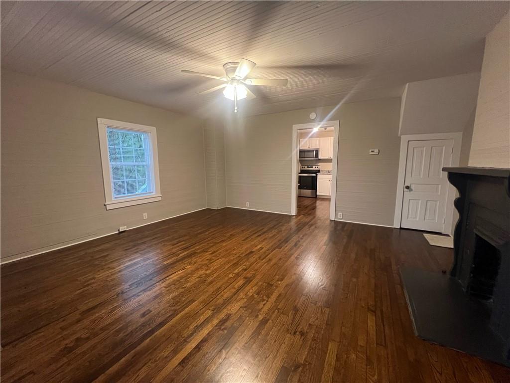 21 Quarry Street Gainesville, GA 30501 - Photo 2 of 8 a view of an empty room with wooden floor and a window