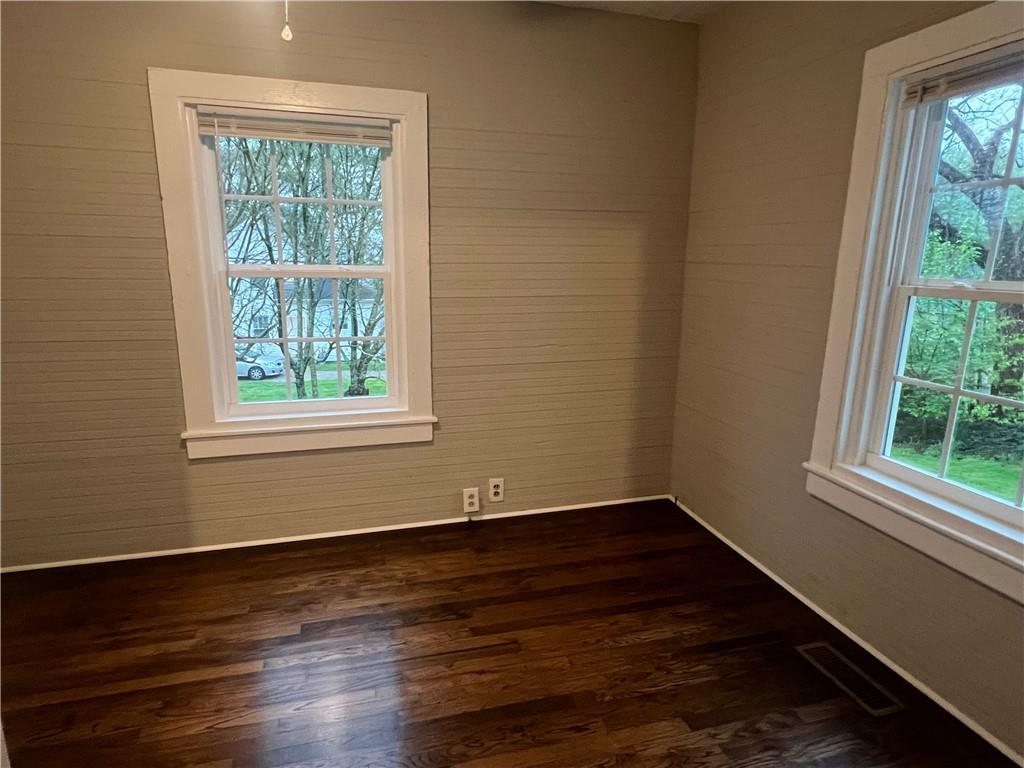 21 Quarry Street Gainesville, GA 30501 - Photo 4 of 8 an empty room with wooden floor and windows