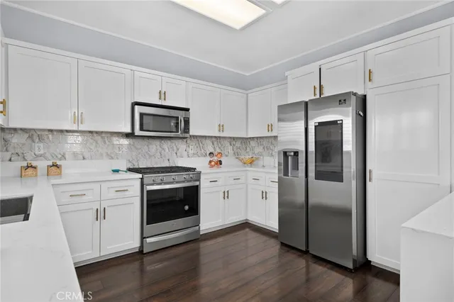 a kitchen with stainless steel appliances a refrigerator stove and microwave