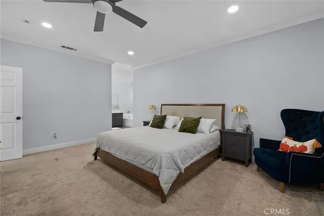 a spacious bedroom with a bed and furniture