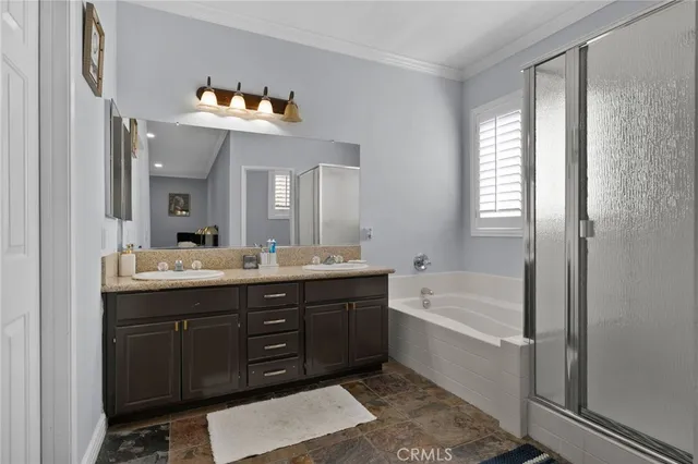 a bathroom with a tub a double vanity sink and a mirror