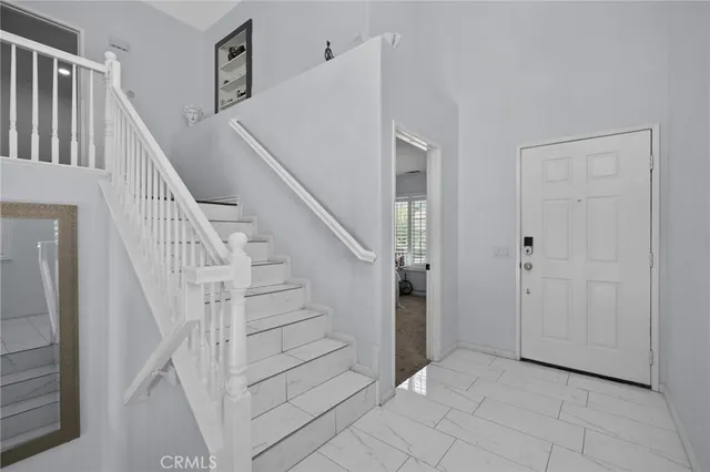 a view of entryway with stairs and wooden floor