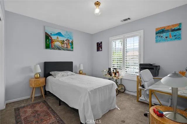 a bedroom with a bed and a desk