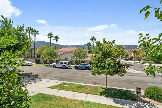 a view of a street with a cars parked