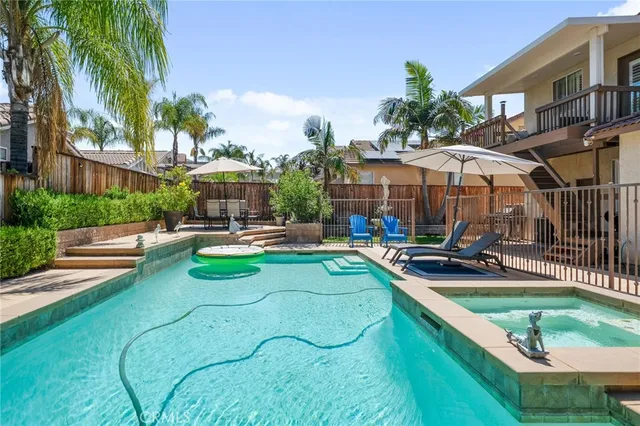 a view of a swimming pool with lounge chairs in patio