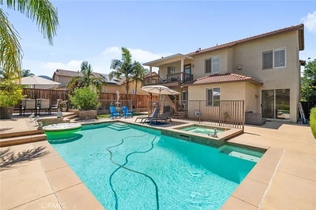 a view of a house with swimming pool and sitting area