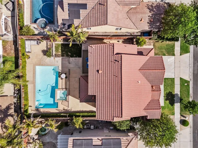 an aerial view of a house with a yard and large tree