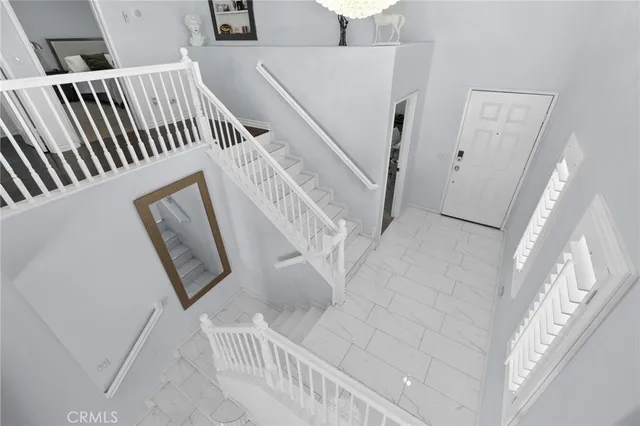 a view of staircase with white walls and a window