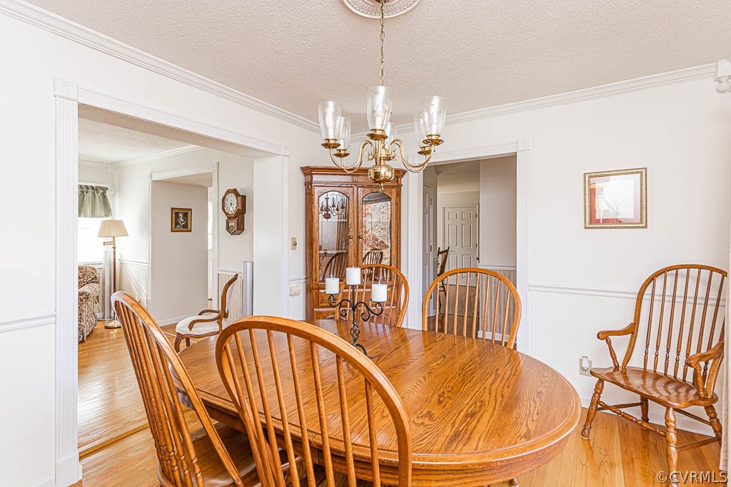 18162 Teman Road Beaverdam, VA 23015 - Photo 11 of 47 a dining room with furniture a chandelier and wooden floor