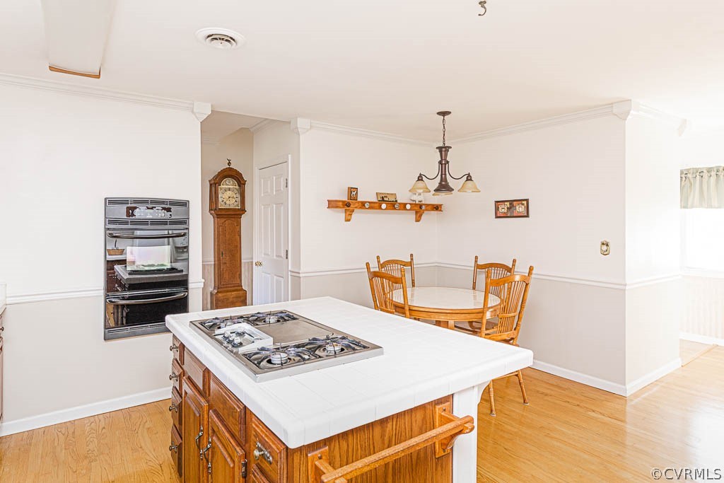 18162 Teman Road Beaverdam, VA 23015 - Photo 16 of 47 a view of kitchen island with a stove a table and chairs