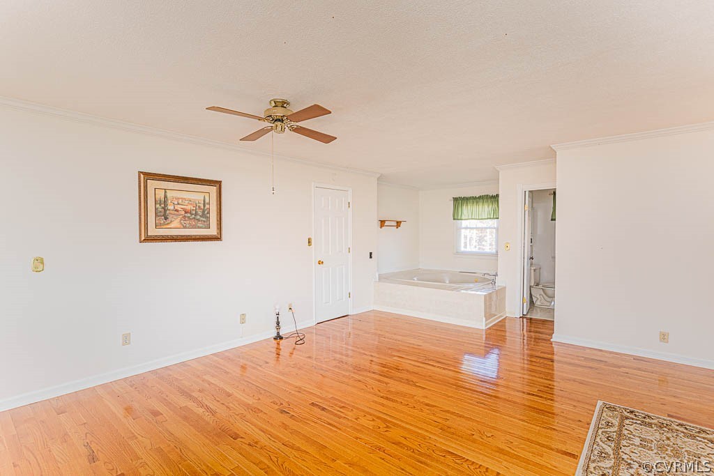 18162 Teman Road Beaverdam, VA 23015 - Photo 21 of 47 a big room with wooden floor and a ceiling fan