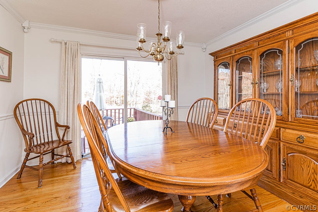 18162 Teman Road Beaverdam, VA 23015 - Photo 10 of 47 a view of a dining room with furniture a chandelier and wooden floor