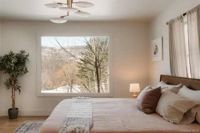 a bedroom with a bed and a window