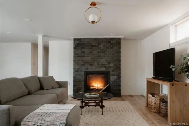 a living room with furniture a fireplace and a flat screen tv