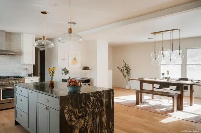 a kitchen with a table chairs refrigerator and cabinets